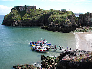 Pleasure boats take passengers aboard on Castle Beach